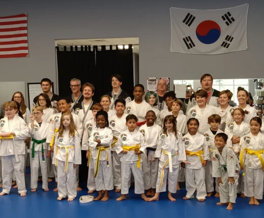 martial arts students taking a group photo with instructors
